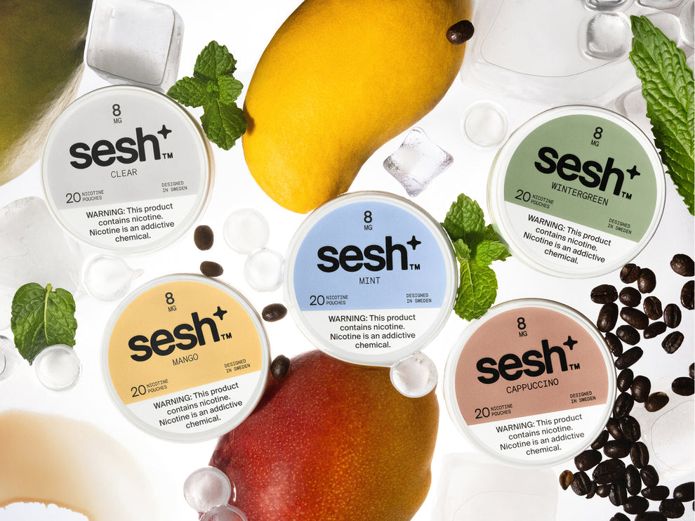 Five 8mg sesh+ nicotine pouch tins in mango, mint, wintergreen, cappuccino, and clear flavors with fresh ingredients.