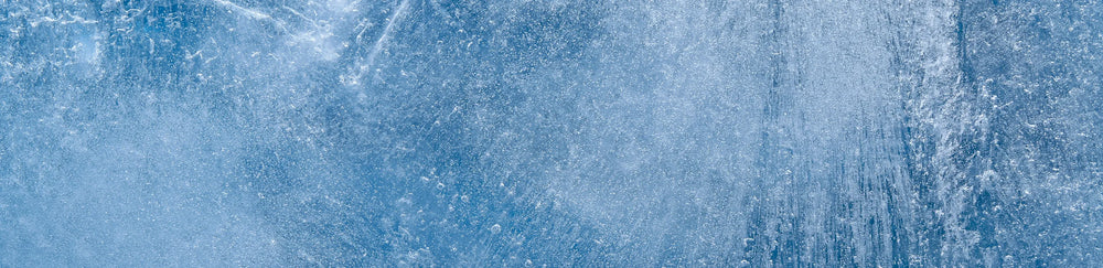Close-up of blue ice texture with frozen air bubbles and crystalline patterns
