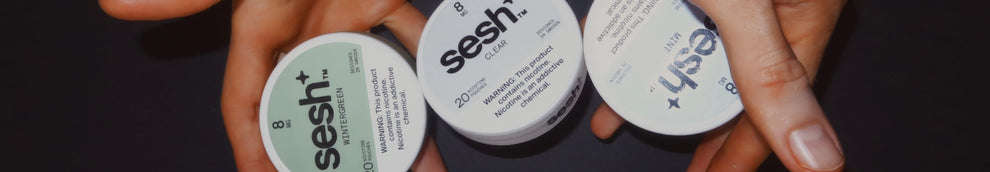 Three cans of sesh+ 8mg nicotine pouches in Wintergreen, Clear, and Mint flavors held in hands